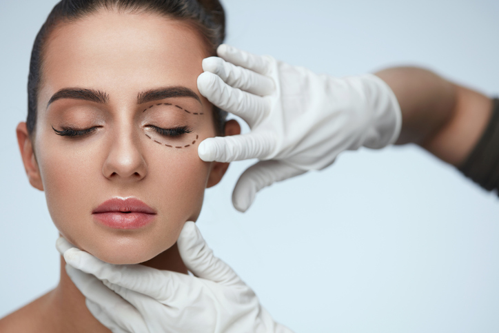 young woman's face being checked for a beauty treatment 